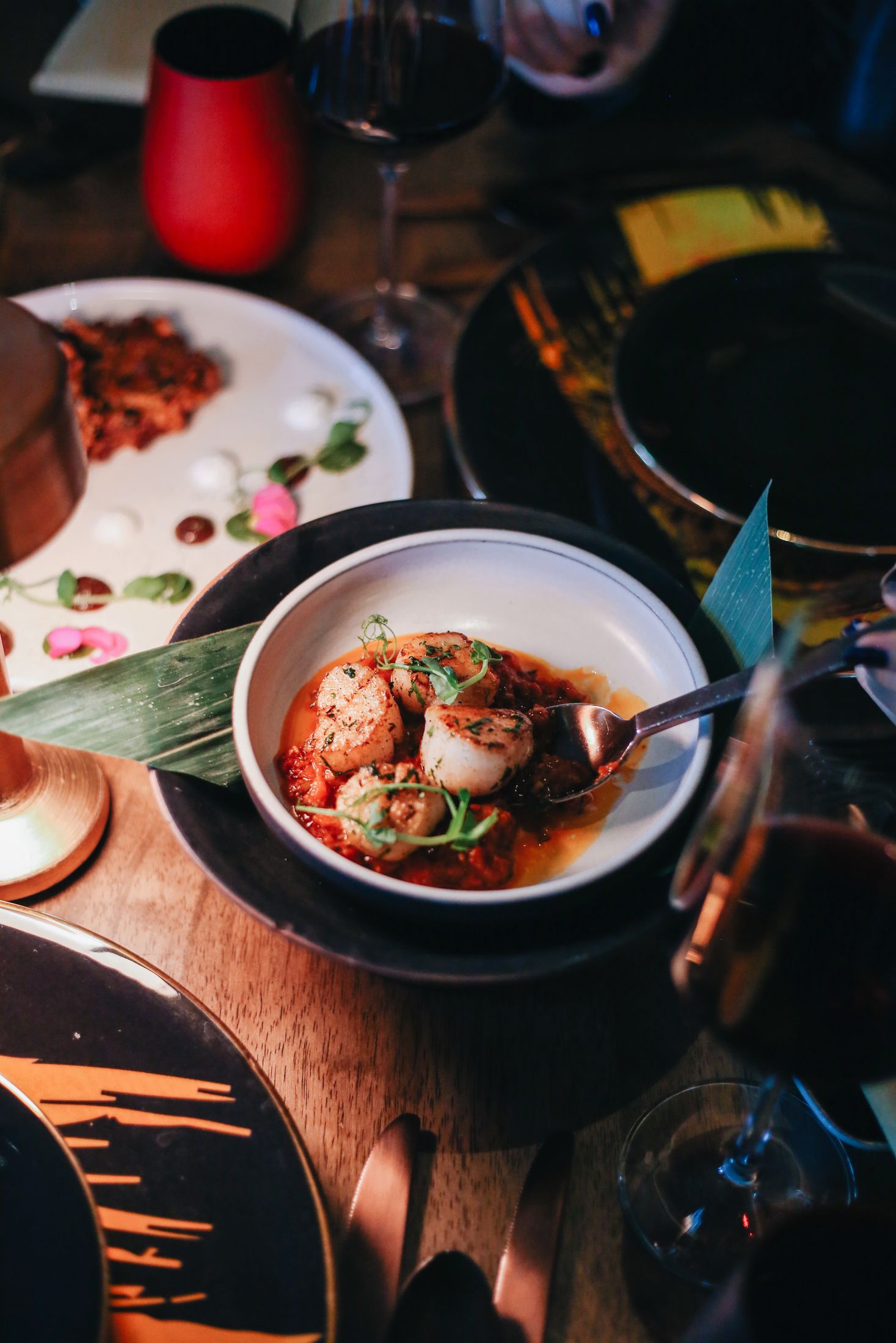 Seared scallops in a spiced tomato sauce