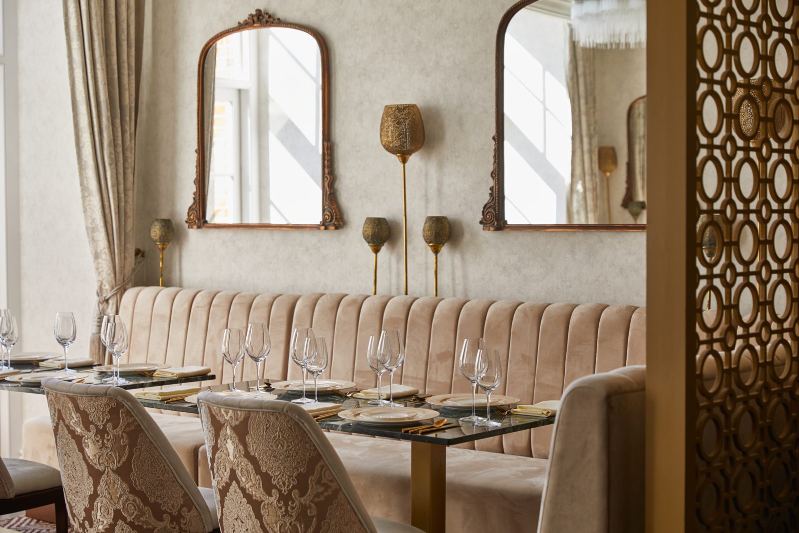 Madhu's at The Grove – dining room with velvet banquette and gilt mirrors